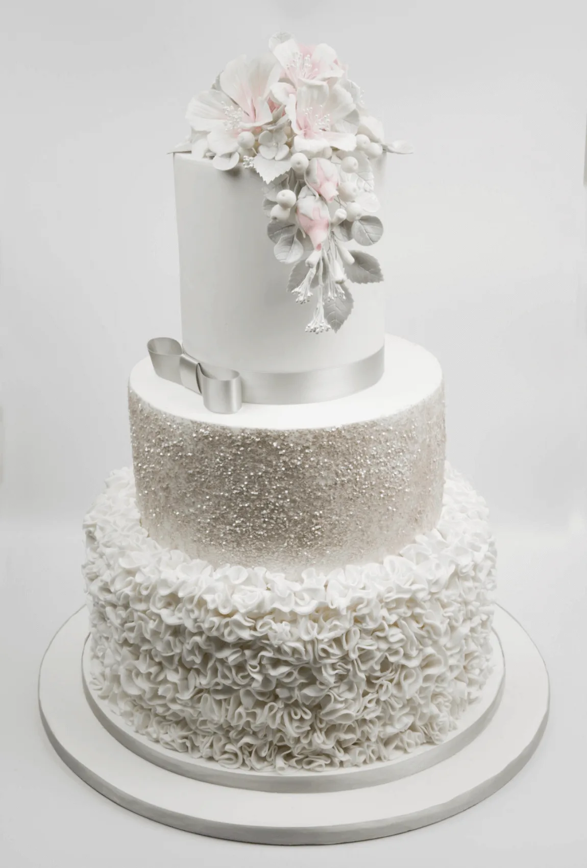 Elegant white bespoke wedding cake with floral details by Anne Robinson, a luxury cake designer in Cambridgeshire – Wedding Cake Design 16