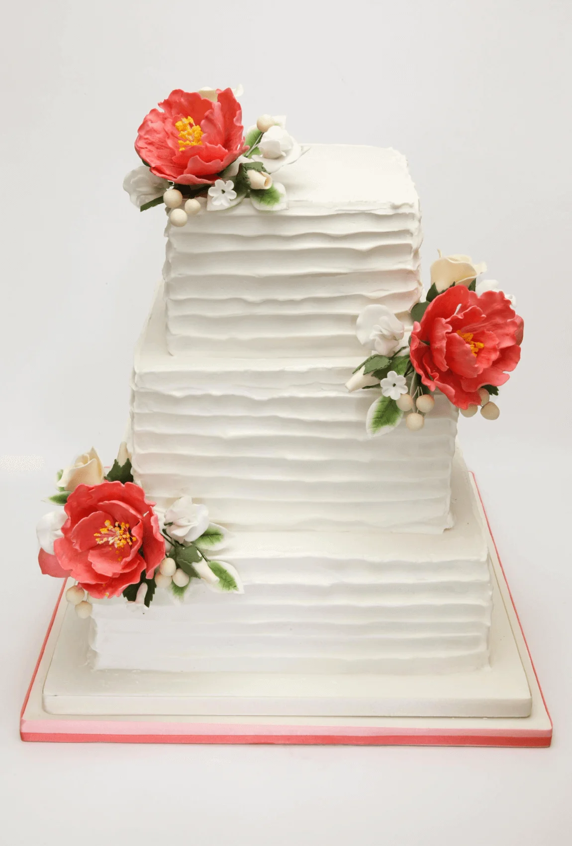 Elegant white bespoke wedding cake with floral details by Anne Robinson, a luxury cake designer in Cambridgeshire – Wedding Cake Design 34