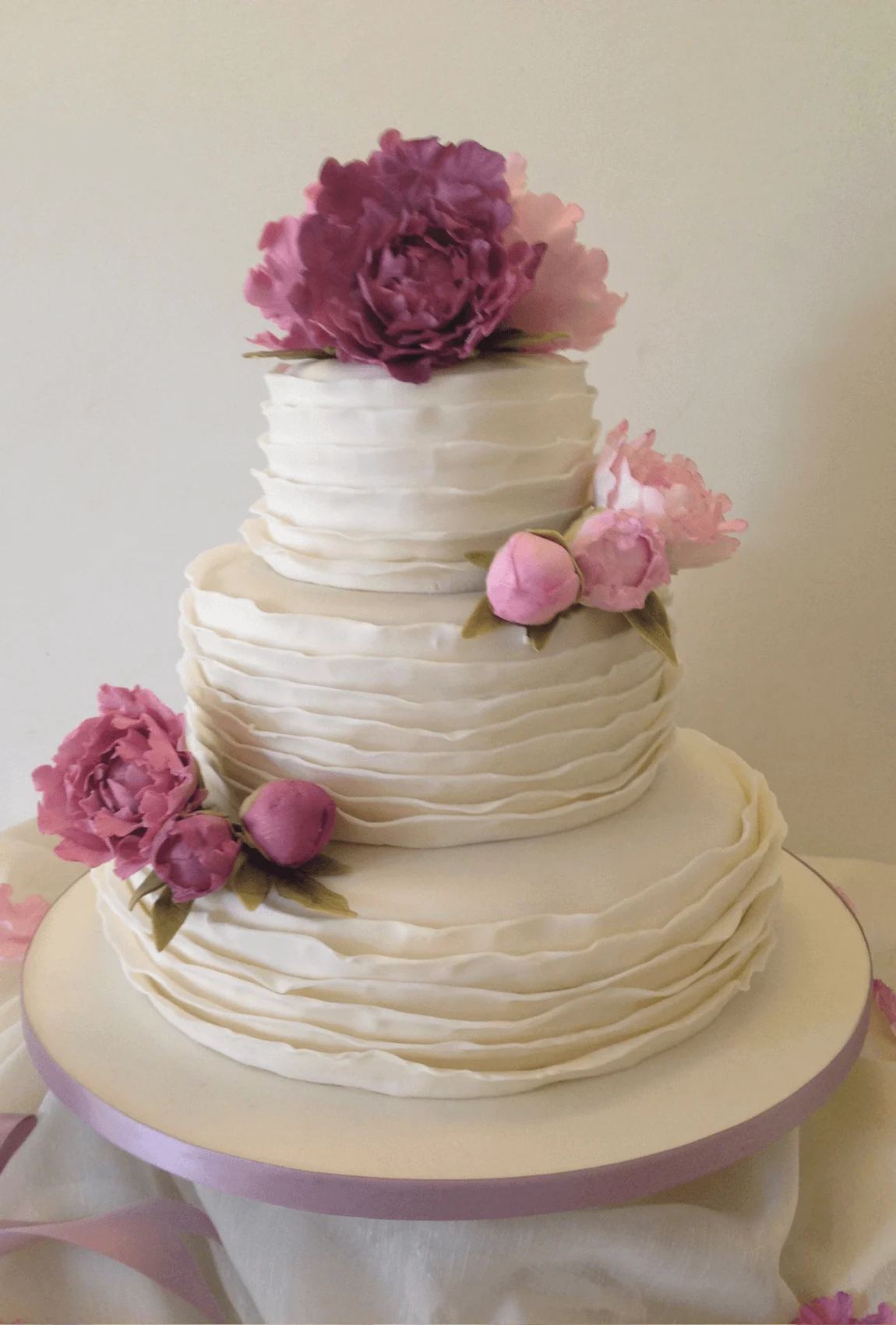 Elegant white bespoke wedding cake with floral details by Anne Robinson, a luxury cake designer in Cambridgeshire – Wedding Cake Design 30