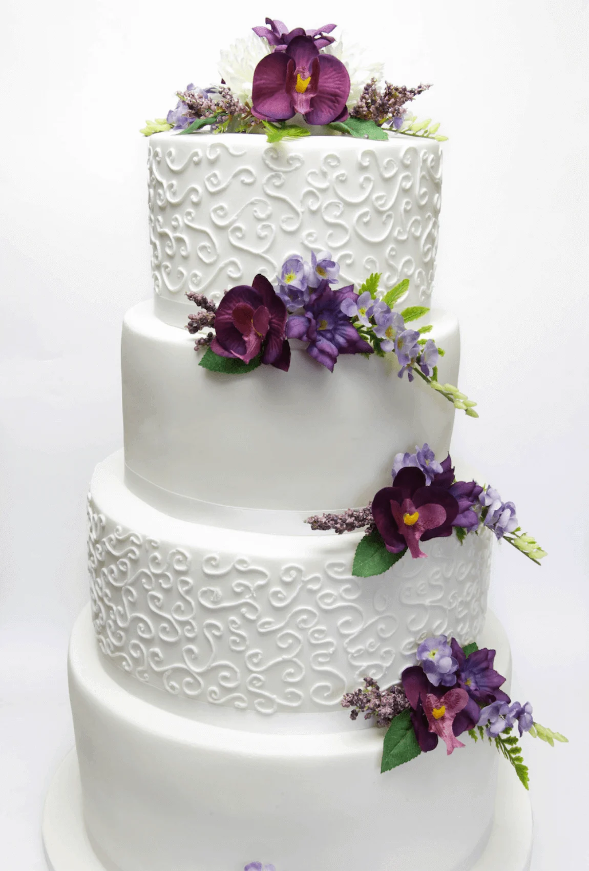 Elegant white bespoke wedding cake with floral details by Anne Robinson, a luxury cake designer in Cambridgeshire – Wedding Cake Design 31