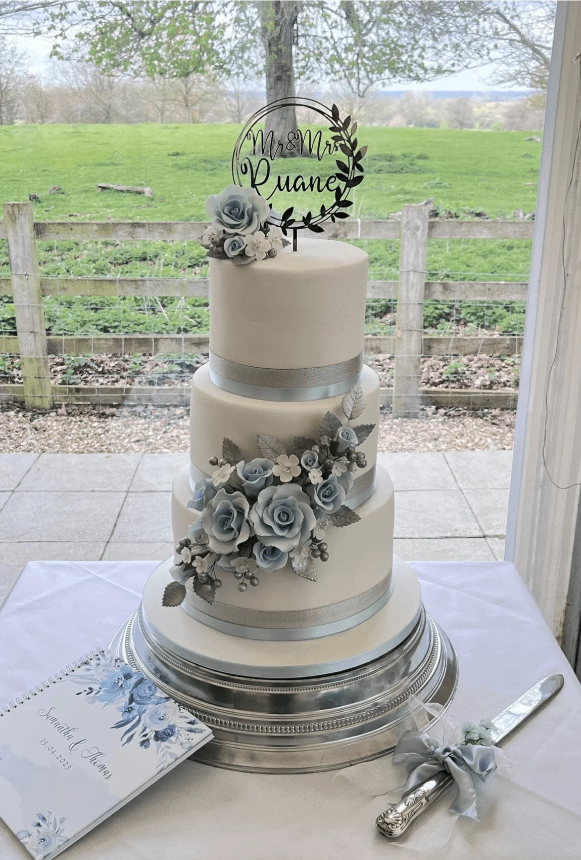 Elegant white bespoke wedding cake with floral details by Anne Robinson, a luxury cake designer in Cambridgeshire – Wedding Cake Design 9