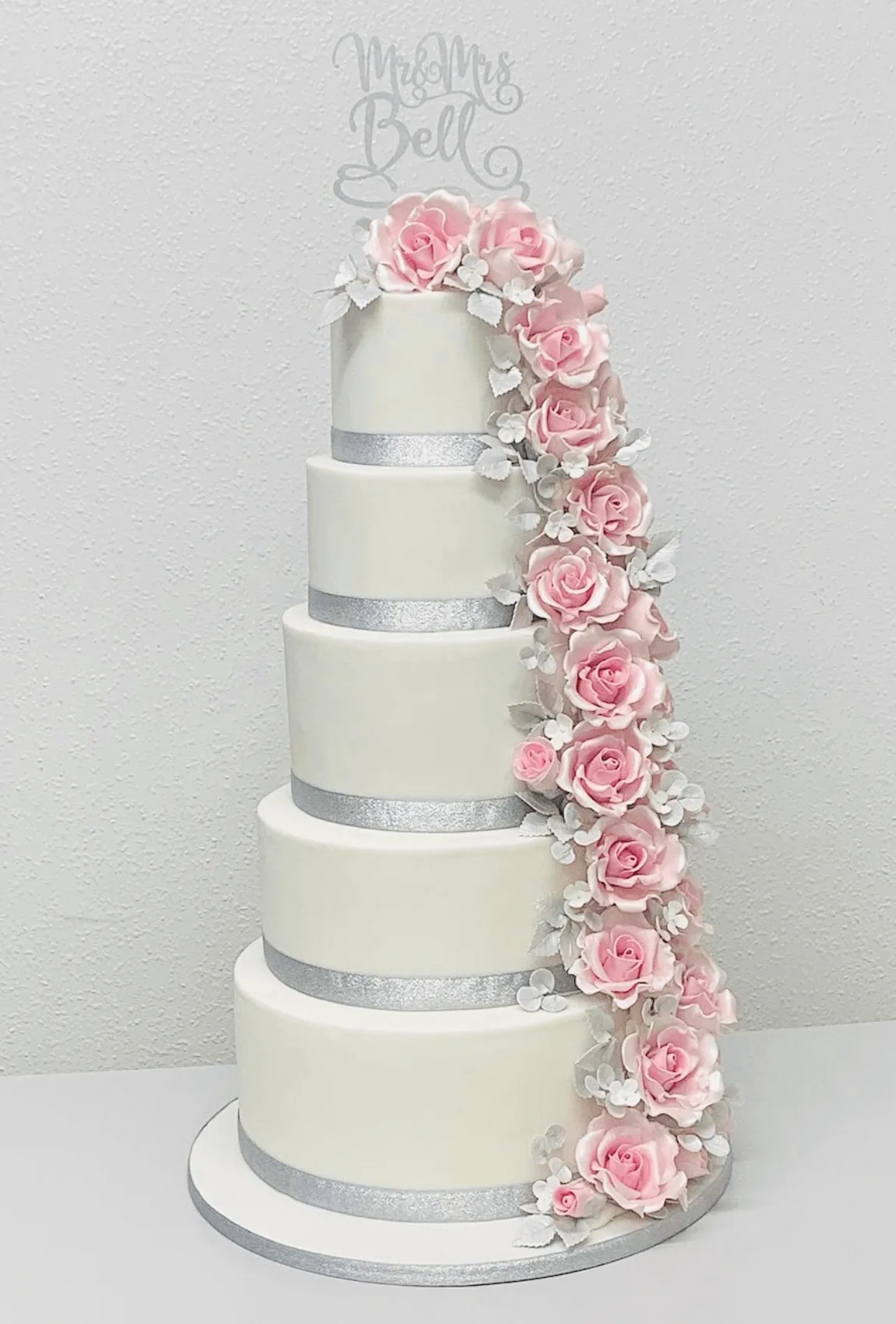 Elegant white bespoke wedding cake with floral details by Anne Robinson, a luxury cake designer in Cambridgeshire – Wedding Cake Design 18