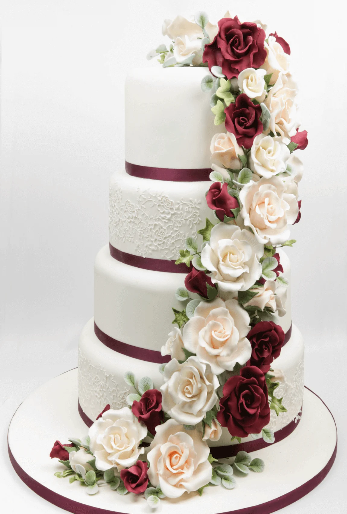 Elegant white bespoke wedding cake with floral details by Anne Robinson, a luxury cake designer in Cambridgeshire – Wedding Cake Design 11