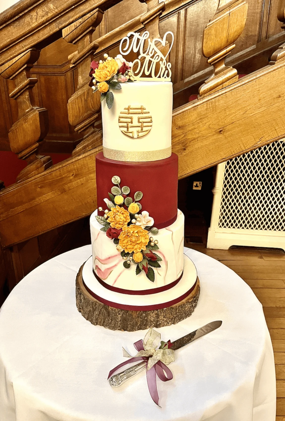 Elegant white bespoke wedding cake with floral details by Anne Robinson, a luxury cake designer in Cambridgeshire – Wedding Cake Design 13