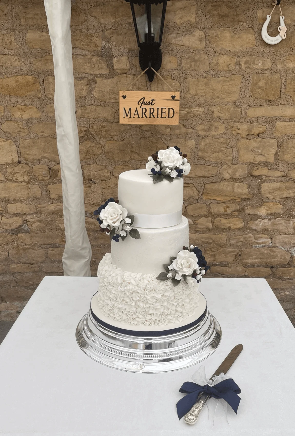 Elegant white bespoke wedding cake with floral details by Anne Robinson, a luxury cake designer in Cambridgeshire – Wedding Cake Design 1.