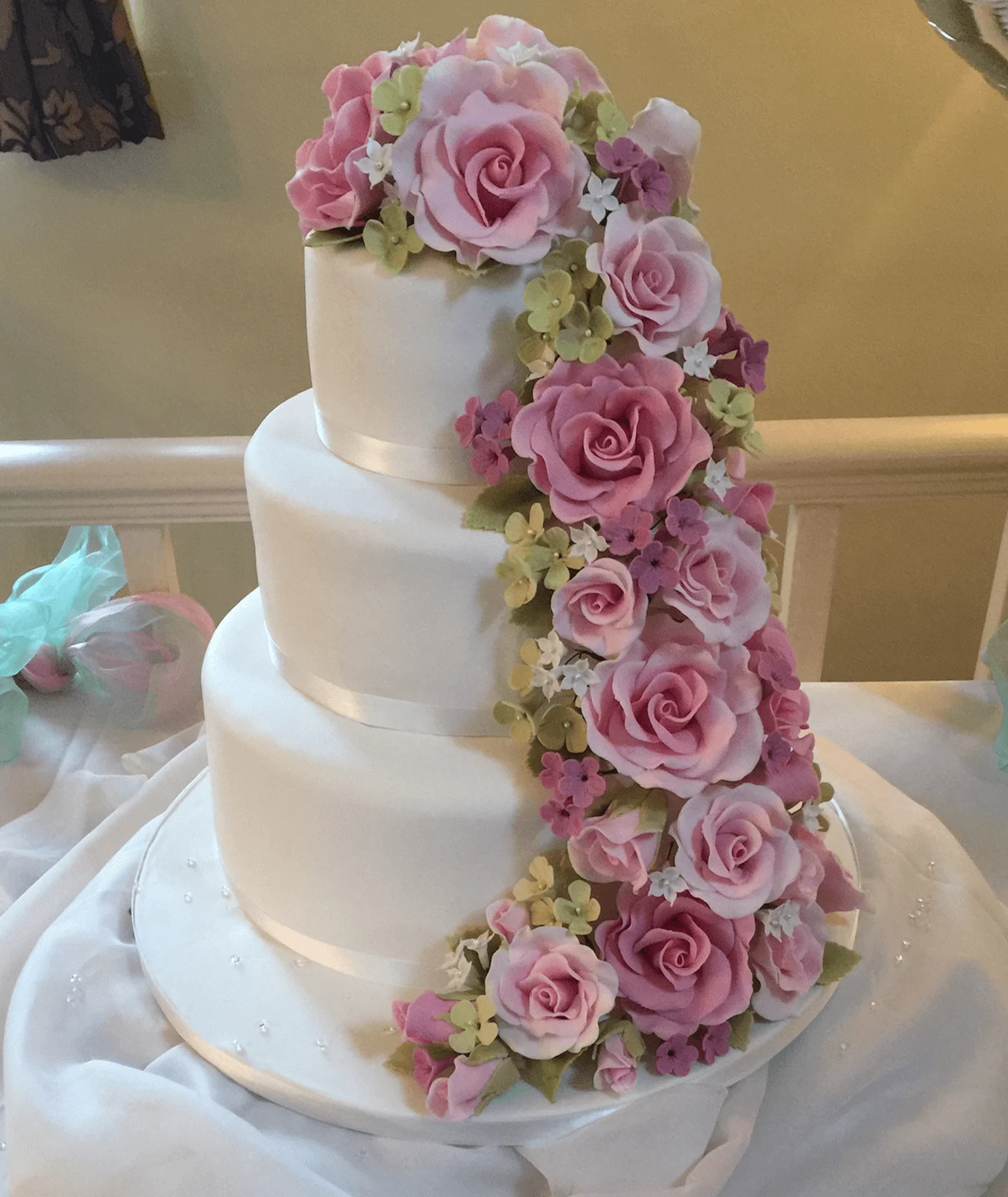 Designer floral wedding cake by Anne Robinson for clients seeking luxury cakes in Cambridgeshire and beyond.